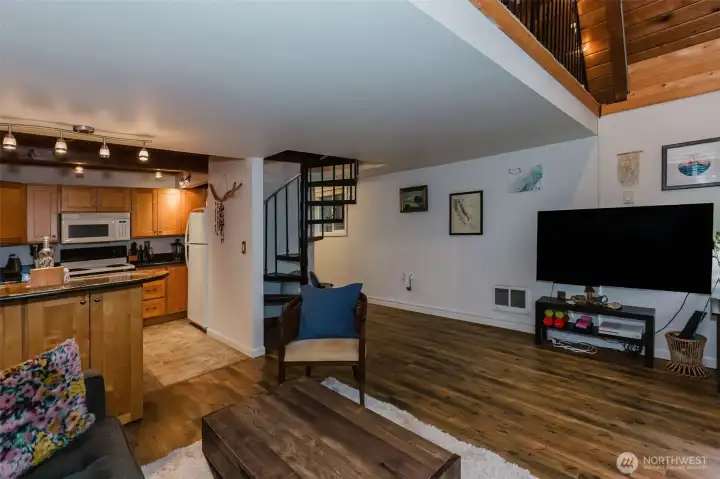 The gracefully curved stairway adds a touch of rustic charm while enhancing the home’s warm, inviting ambiance. Its design creates a cozy, romantic atmosphere that beautifully complements the character of the space.