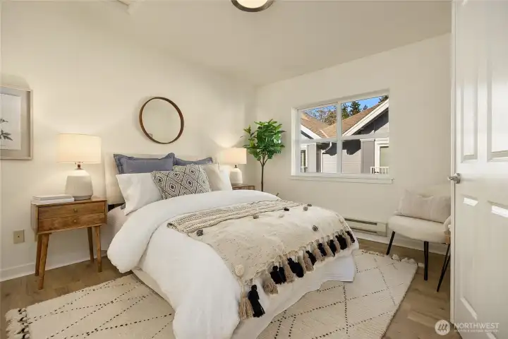 The bright and spacious primary suite with operating windows and closet that encompasses a full wall for great storage.