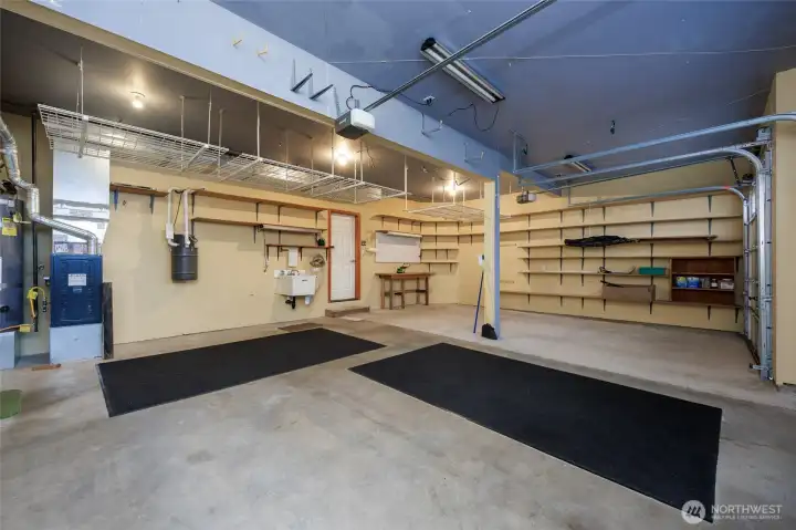 Garage also features: sink, central vacuum system, sprinkler system wall of shelves and   NEW Furnace (2025)