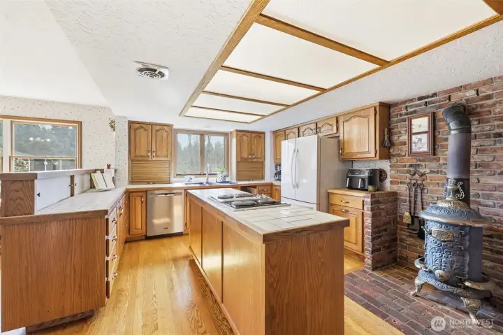 Kitchen features a pot-belly stove.