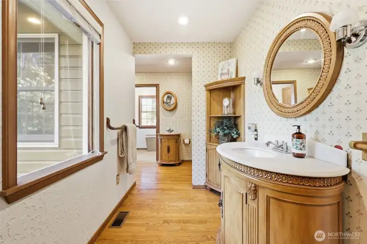 The main bathroom is very spacious! There is a pocket door that leads to the laundry room.