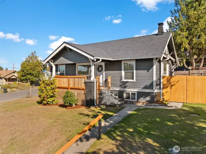 This beautiful Craftsman sits perched up high on a corner lot with views of the Port of Tacoma