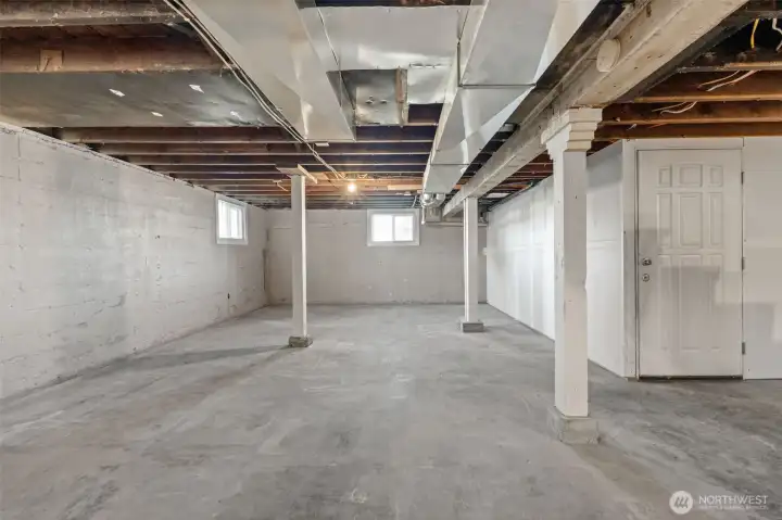 Large unfinished basement with water, electric, and separate entrance
