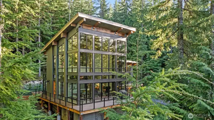 Absolutely stunning glass walls. While in this beautiful home you feel as if you are in a elegant tree house with glass wall all around you.