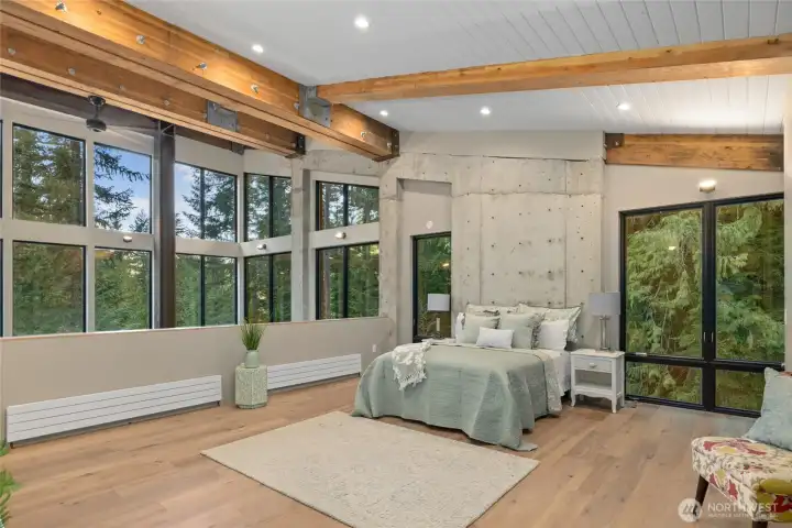 On the upper floor is the grand primary bedroom, where you have windows 360 degrees. The beams and hardware give a great mountain home feeling. This bedroom is large, you have room for anything you might want to add. Maybe an execise area or a small office are.
