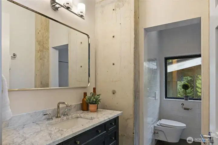 The primary bedroom bath has heated floors, like the rest of the house, and an elegant European bath and huge shower.