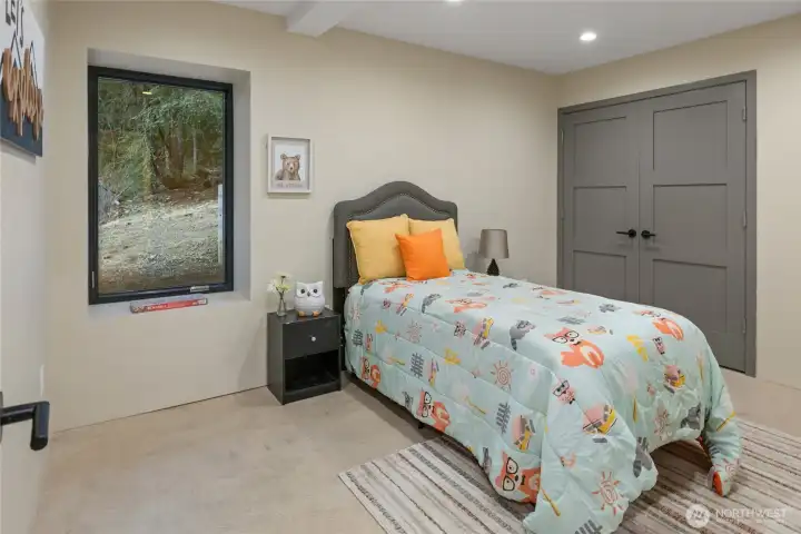 View of one of the 2 lower floor bedrooms. It is so nice to step out of bed to the heated floors.