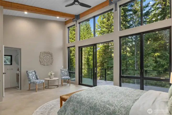 Who would not want to stay here? The floor to ceiling windows bring in nature and gives that "tee house" feeling again. You can see entrance into the guest house bathroom.