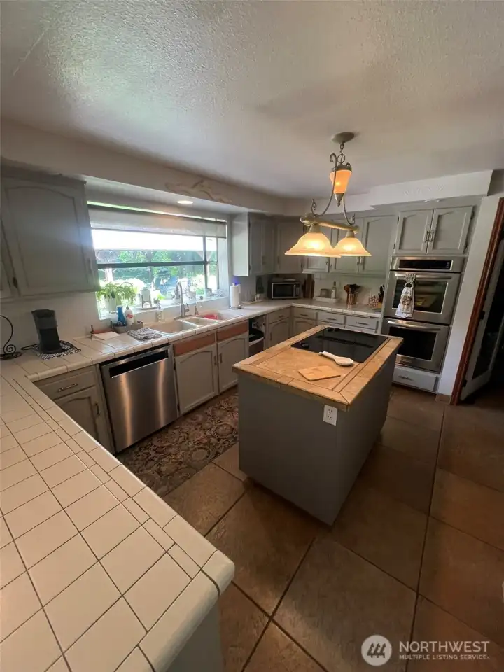 Kitchen with cooktop Island and double oven.