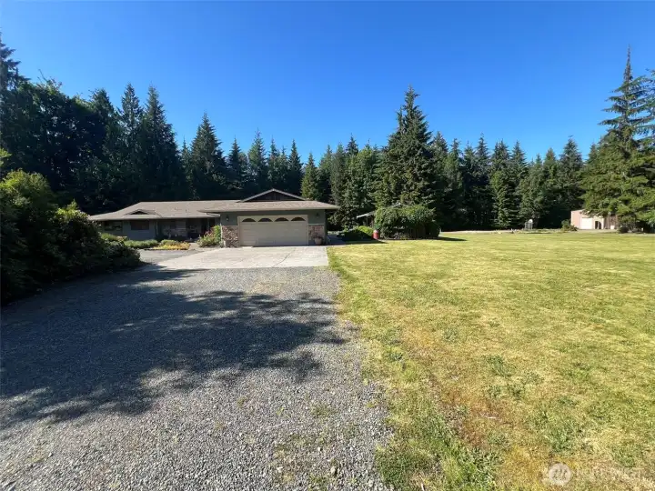 Front of house showing large sunny yard area perfect for garden or other activities