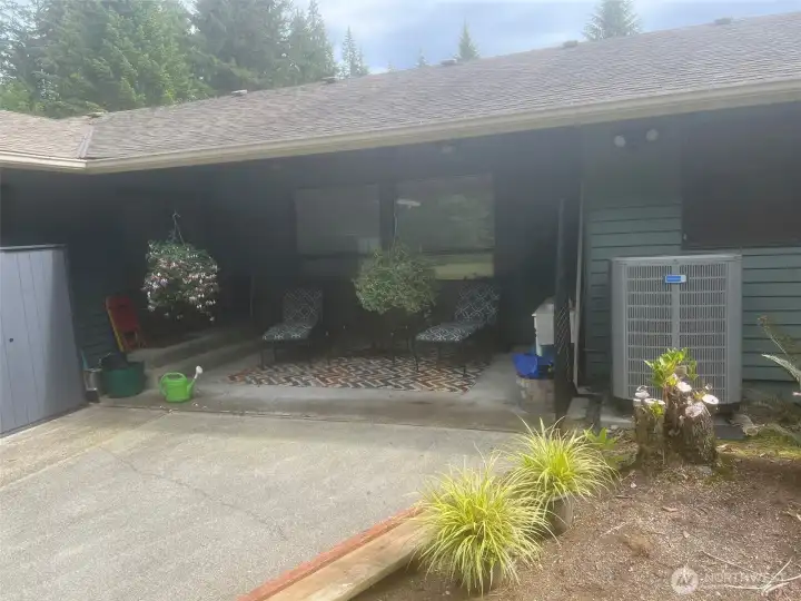 Back of home showing private covered patio