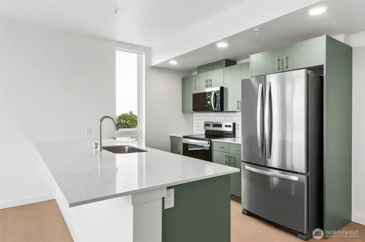 Quartz countertop island provides prep space, casual eating, storage, etc.. Quartz countertop island provides prep space, casual eating, storage, etc..