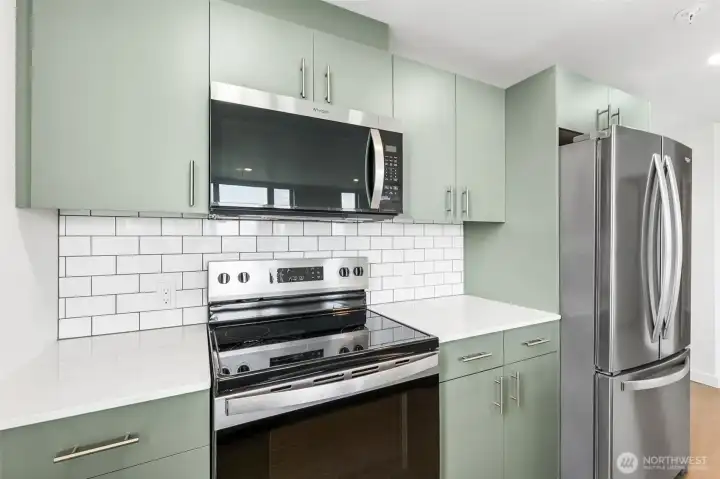 Energy efficient stainless steel appliances, tiled backsplash and quartz countertops and stylish cabinets Energy efficient stainless steel appliances, tiled backsplash and quartz countertops and stylish cabinets