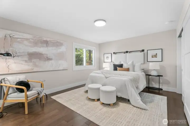 Spacious and calming, the primary bedroom features designer wood blinds and 2 closets Spacious and calming, the primary bedroom features designer wood blinds and 2 closets
