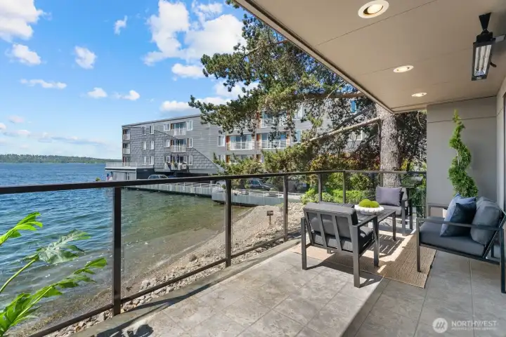 Large partially covered deck has stunning glass railings to enhance the view. Private beach is yours to enjoy and just steps away. Large partially covered deck has stunning glass railings to enhance the view. Private beach is yours to enjoy and just steps away.