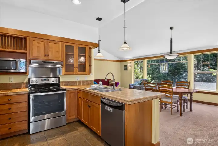 I love the openness of the kitchen, and the flow to the dining and living. The fireplace is off to the right and the door to the outside deck is just beyond that. I love the openness of the kitchen, and the flow to the dining and living. The fireplace is off to the right and the door to the outside deck is just beyond that.