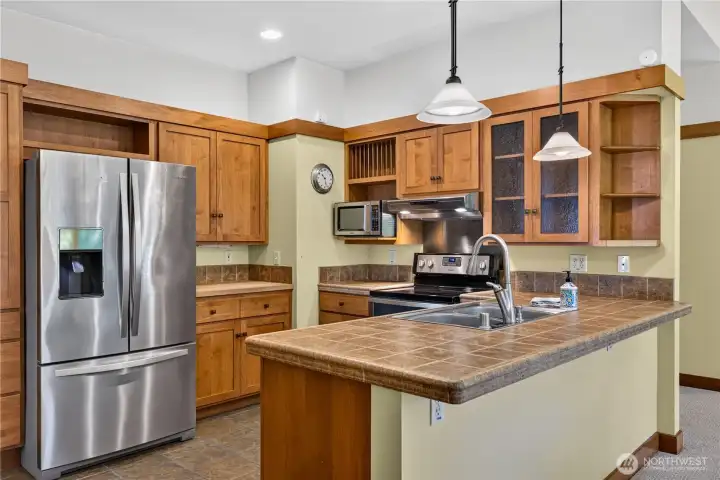 Large open kitchen overlooking living & dining areas and the beautiful garden & trees outside Large open kitchen overlooking living & dining areas and the beautiful garden & trees outside