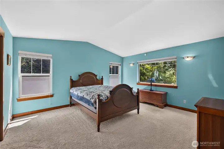 The primary bedroom downstairs feels like you’re living in a lovely forest retreat. The primary bedroom downstairs feels like you’re living in a lovely forest retreat.