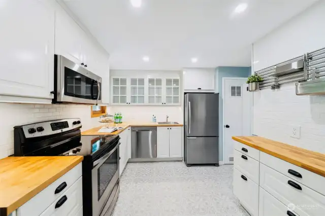 Stainless steel appliances and butcherblock countertops.