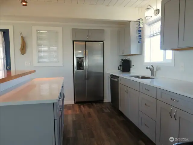 KTCHEN HAS PLENTY OF COUNTER SPACE AND CABINETS, PLUS THE STAINLESS STEEL REFRIGERATOR AND DISHWASHER STAY WITH THE HOME!