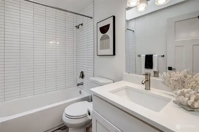 Bathroom featuring classic subway tiles and a skylight, bringing in abundant natural light and a sophisticated touch.