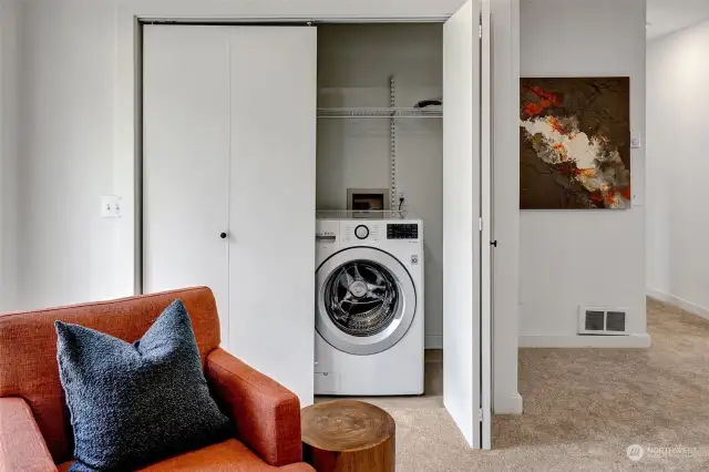 Laundry closet with a touch of convenience—half-open to showcase its organized, easy-access design.