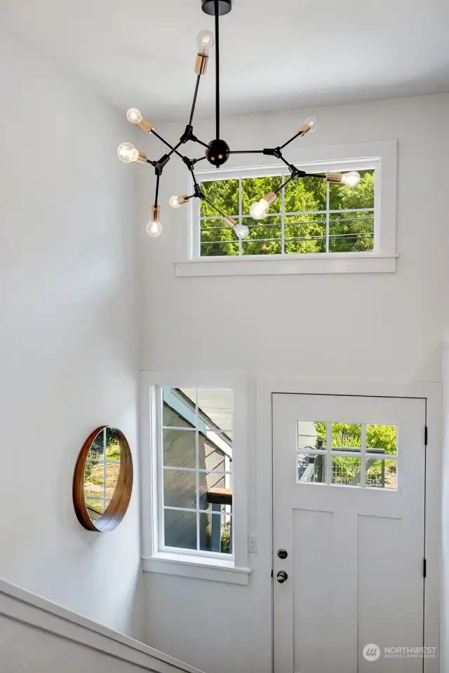 Split-level entry featuring an eye-catching chandelier—adding a touch of elegance and style to your welcome.