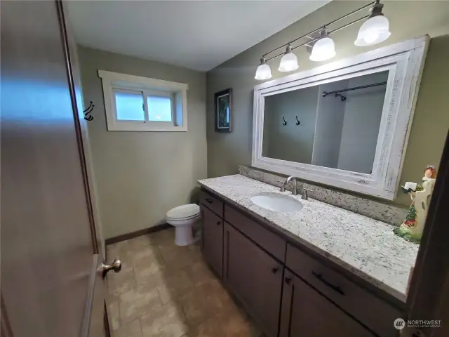 Nice bathroom with granite countertop and heated tiled floors.