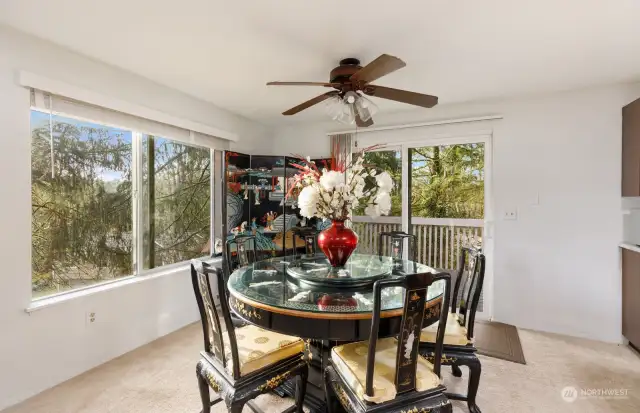 Large dining space off the kitchen features plenty of natural light and access to deck. Plenty of trees around this property make it serene and private.