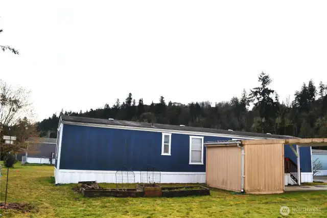 The yard space immediately behind the shed is yours! The raised beds need a little TLC to make them thrive again, or you could do something completely different with the space.