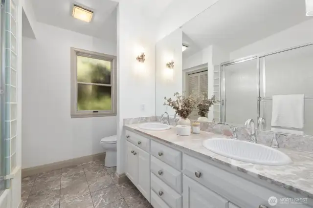 A generously sized full bathroom on the main level, filled with natural light and thoughtfully designed for ease and comfort.