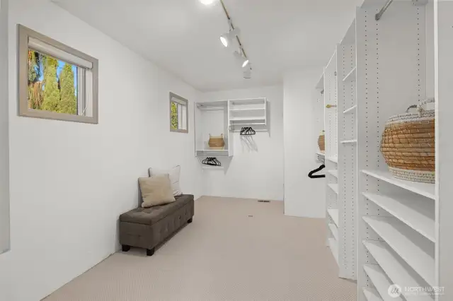 The primary suite features a spacious, light-filled walk-in closet designed for both style and functionality.