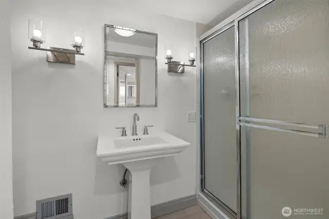 Lower-level 3/4 bath offers everyday convenience with practical design and functionality.