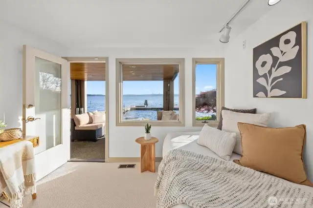 Flexible lower-level bedroom or office with direct access to the patio, dock, and private beach.