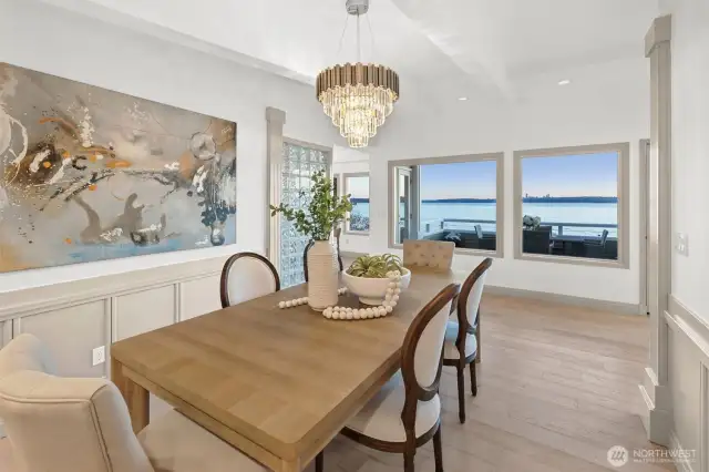 An elegant dining room offers southwest-facing, expansive views—the perfect setting for gatherings, celebrations, and savoring every moment of lakeside enjoyment.