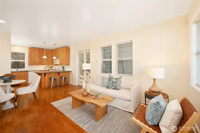 Light and bright living area with gleaming real hardwood floors on the main level. This home is freshly painted within and has new carpet leading upstairs and in the bedrooms. The open layout and vaulted ceilings create a spacious and efficient living space with no wasted square footage.