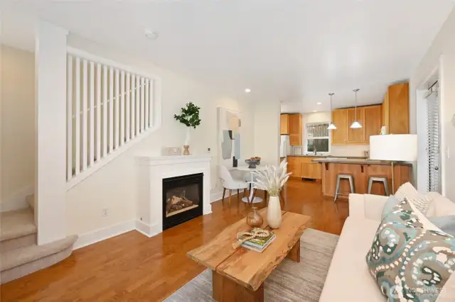 Light and bright living area with cozy gas fireplace. Notice the open picket staircase which makes this home feel so open and airy.