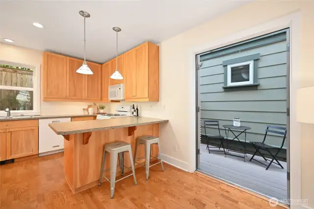 Eating area around kitchen peninsula. There is another storage cabinet built in under the counter.