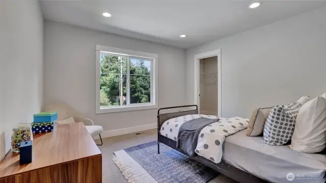 Upper level guest bedroom #1 boasts a walk-in closet.
