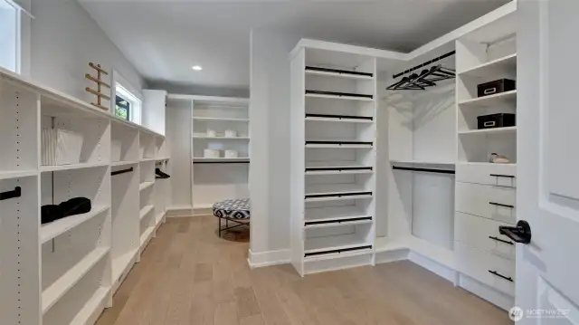 Here is the expansive primary walk-in closet featuring dual sides, organized built in's, shoe storage and space for more.