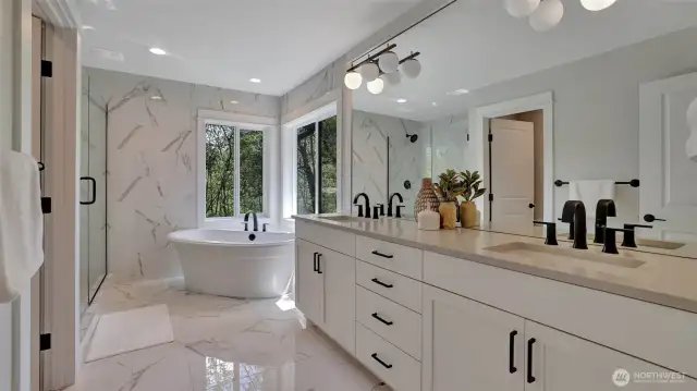 Another beautiful bathroom! Floor to ceiling tile, oversized mirror and expansive vanity.