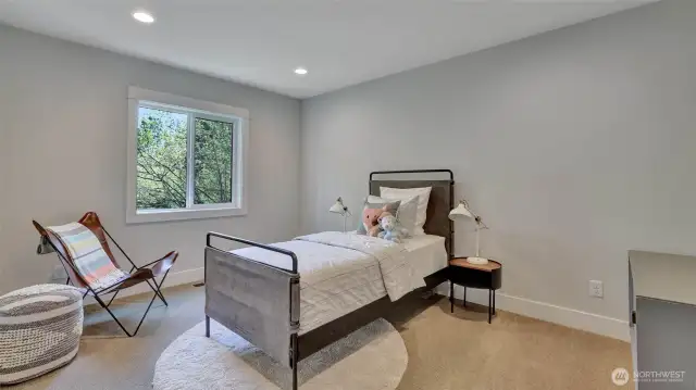 Upper level guest bedroom #2 boasts a walk-in closet.