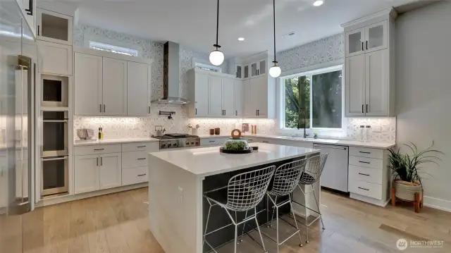 Such an amazing kitchen complete with high end Electrolux appliances including a double refrigerator/freezer and five burner gas cooktop. The oversized countertops, waterfall island and tilework is a piece of art.