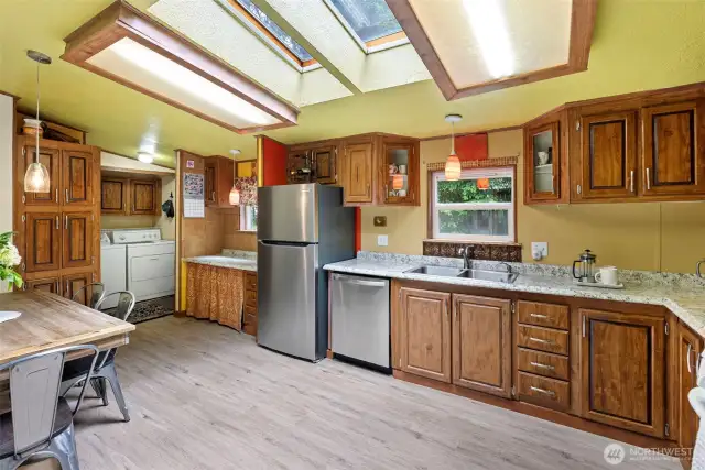 The kitchen is large enough for a dining table and is connected to the utility area and back porch.