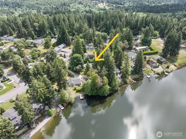 The home is adjacent to the lake and boarded by a green belt.