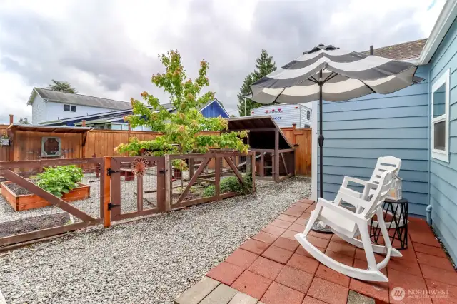 Uncovered back yard seating area overlooking the garden