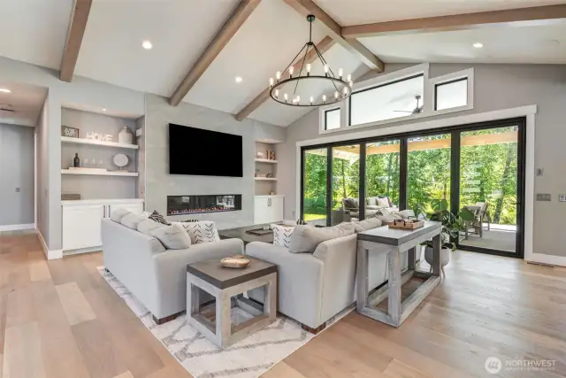 Living Room featuring quality lighting, built-in shelving, gas propane fireplace.