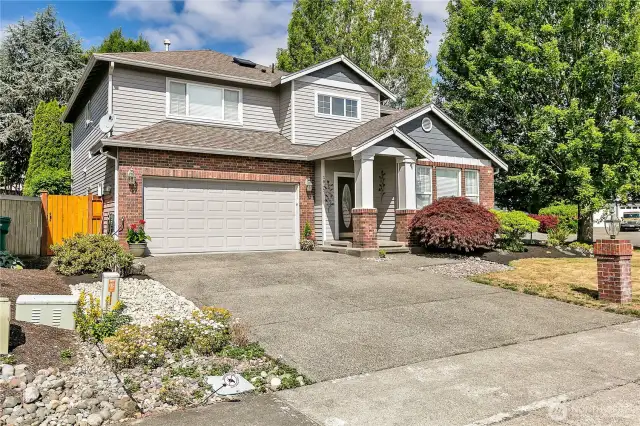 The home is situated on a corner of the cul-de-sac, and the lot comprises 7,115 square feet. The exterior features a porch and brick.