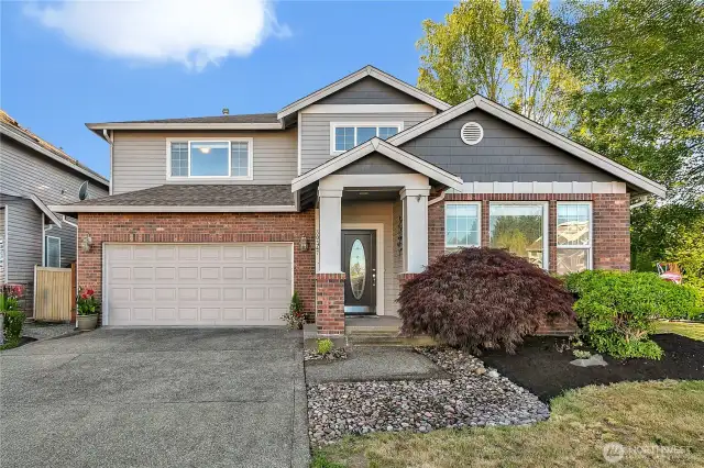 The home is situated on a corner of the cul-de-sac, and the lot comprises 7,115 square feet. The exterior features a porch and brick.