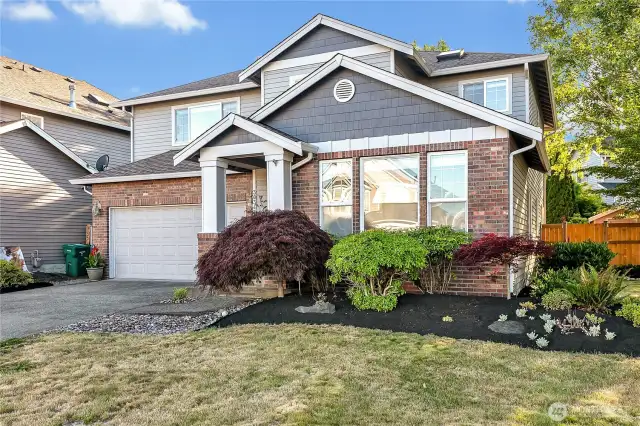 The home is situated on a corner of the cul-de-sac, and the lot comprises 7,115 square feet. The exterior features a porch and brick.